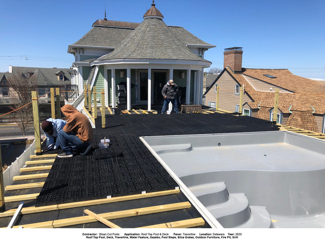 Black SilcaGrate panels installed over deck framing beside a hot tub.