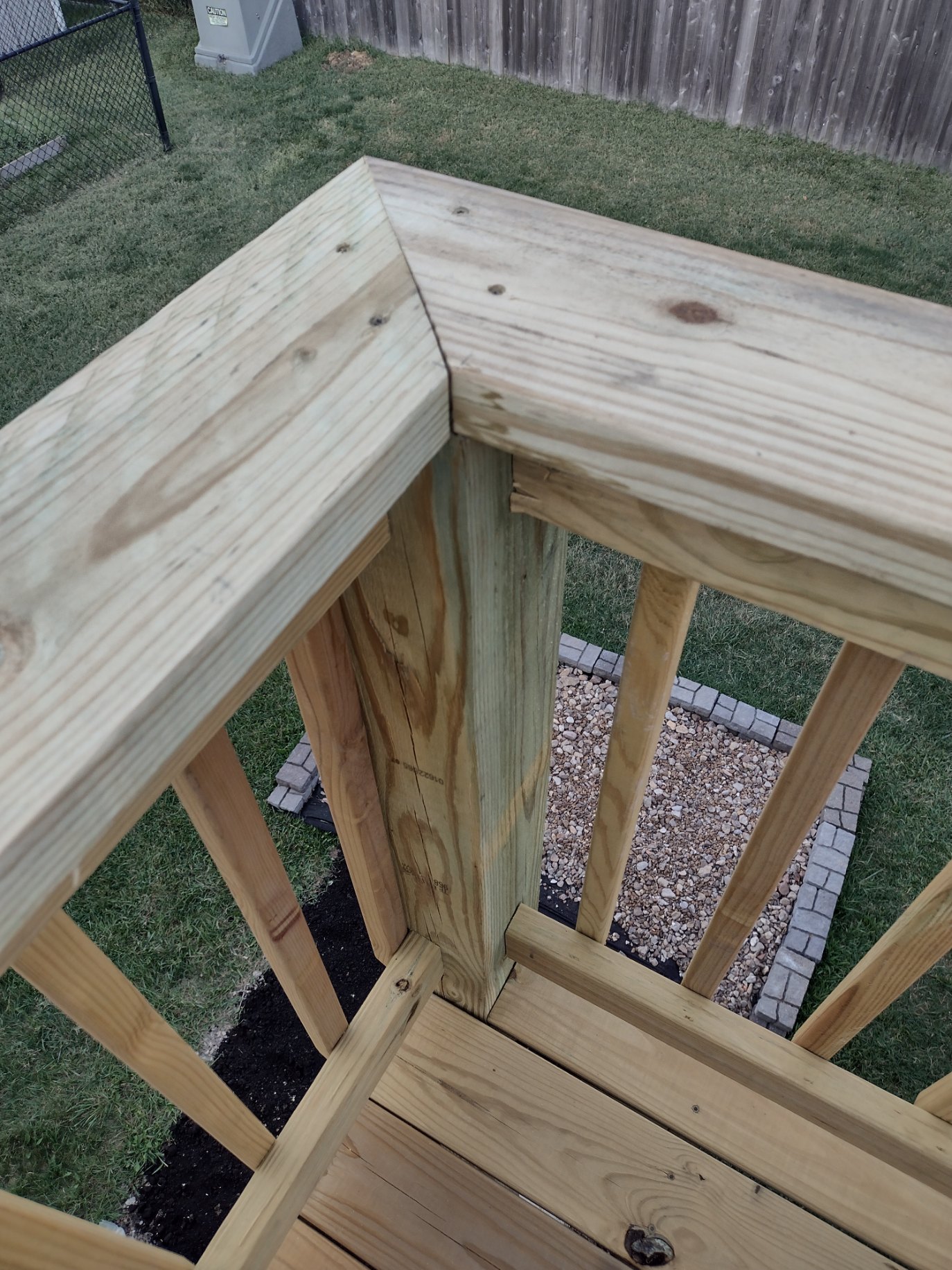 Deck railing corner in Kansas City with a tight mitered top rail joint on install day